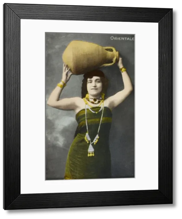 Framed Print : An Egyptian woman holding aloft a large pottery jar Framed Print : An Egyptian woman holding aloft a large pottery jar