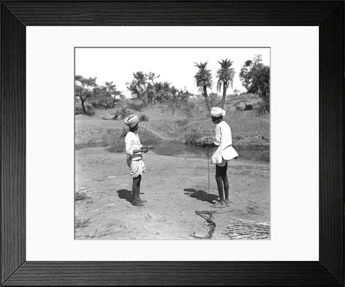 Framed Print : Two Men tie reeds by a stream Framed Print : Two Men tie reeds by a stream