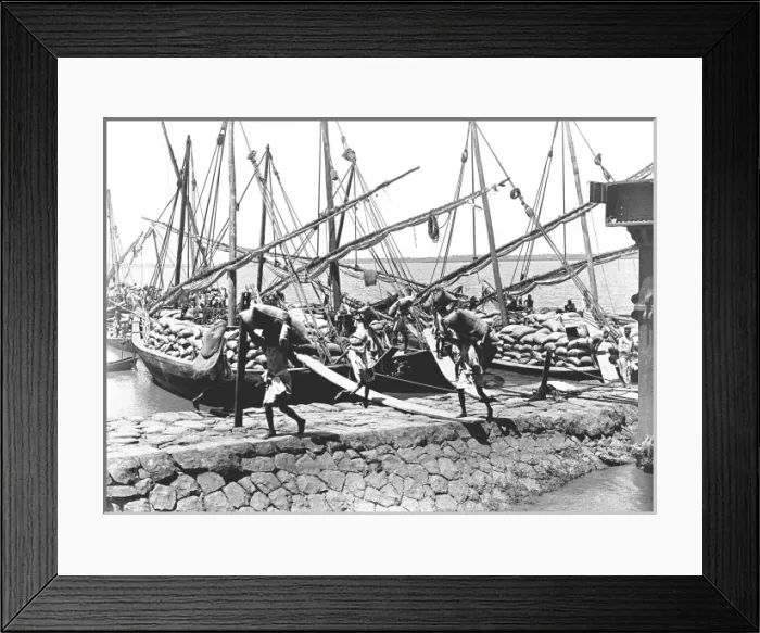 Framed Print : Natives unloading cargo from boats Framed Print : Natives unloading cargo from boats