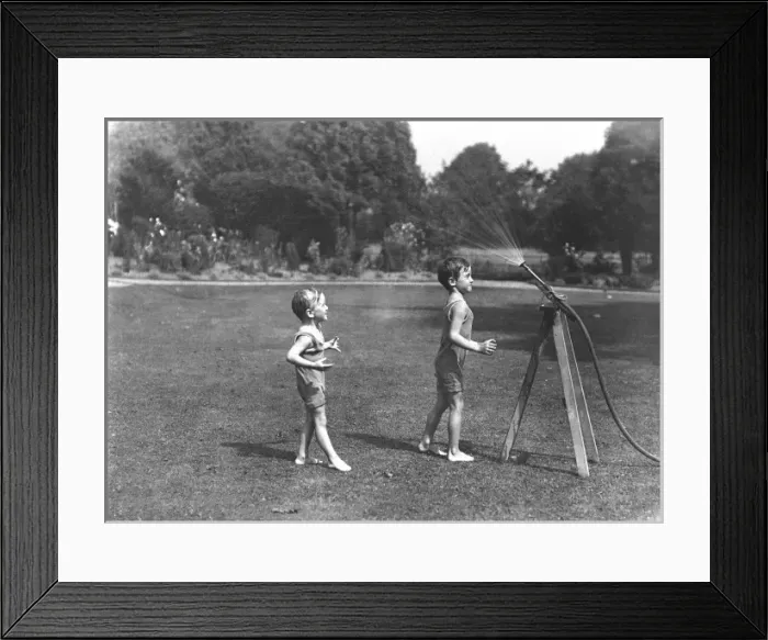 Framed Print : Two boys with a water hose in a Devon garden Framed Print : Two boys with a water hose in a Devon garden