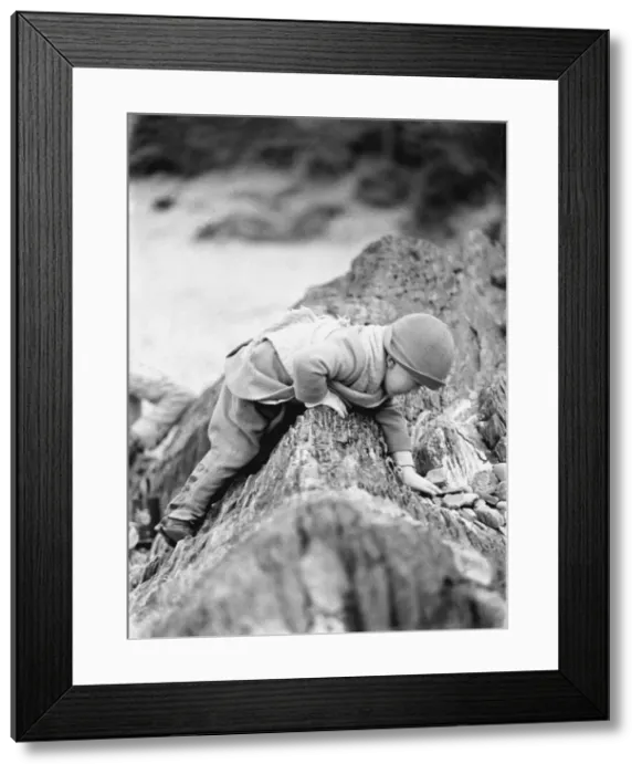 Framed Print : Small toddler playing on seaside rocks, Devon Framed Print : Small toddler playing on seaside rocks, Devon