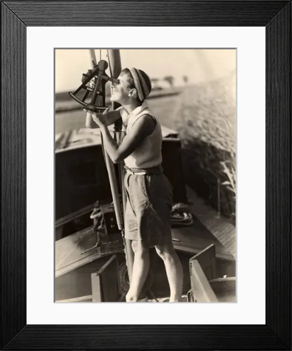 Framed Print : Woman looks through sextant on board a boat Framed Print : Woman looks through sextant on board a boat