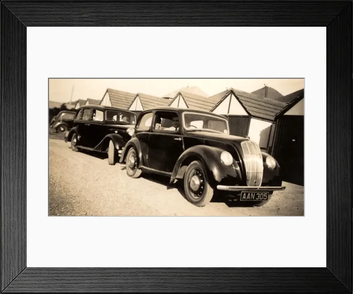 Framed Print : Cars parked by a row of garages Framed Print : Cars parked by a row of garages