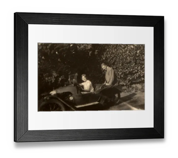 Framed Print : Couple in a tiny three-wheeled car Framed Print : Couple in a tiny three-wheeled car