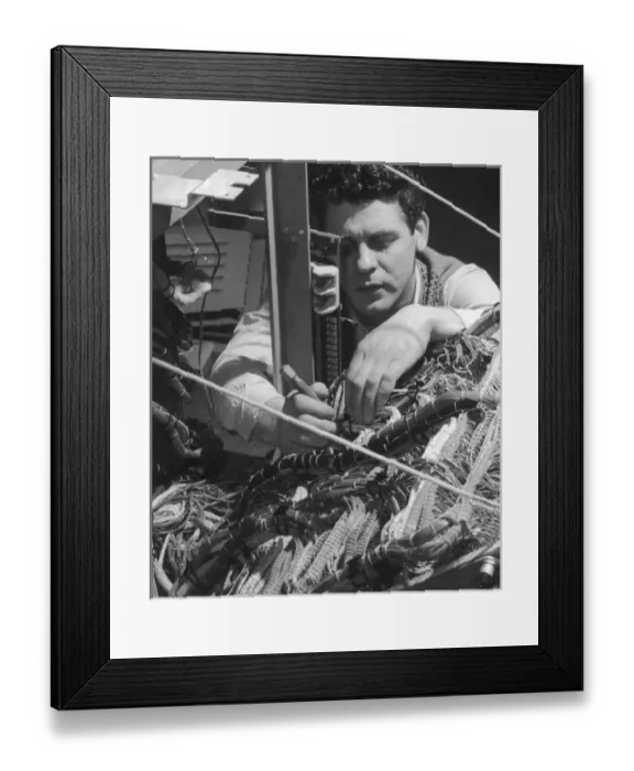 Framed Print : A technician works on a wiring system Framed Print : A technician works on a wiring system