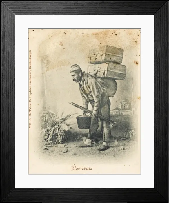 Framed Print : Turkish porter carrying two suitcases Framed Print : Turkish porter carrying two suitcases