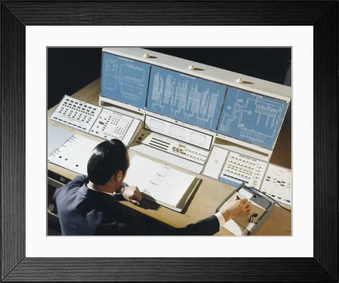 Framed Print : Factory technician at the control desk Framed Print : Factory technician at the control desk