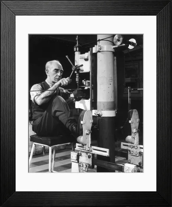 Framed Print : A metalworker operating a drill Framed Print : A metalworker operating a drill