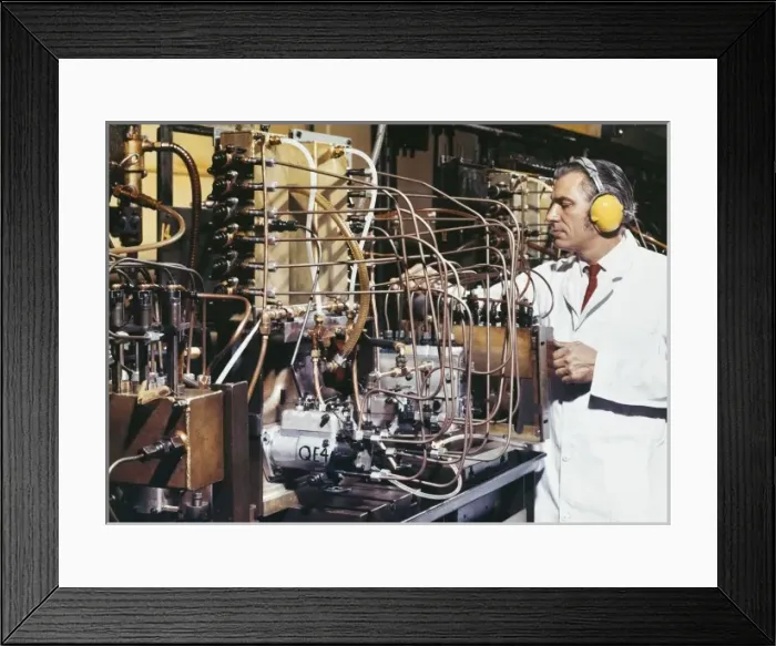 Framed Print : A technician adjusts delicate pipework Framed Print : A technician adjusts delicate pipework