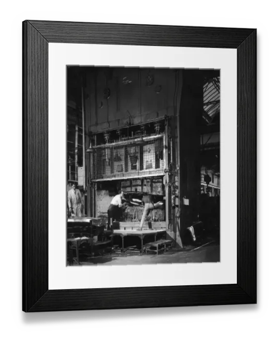 Framed Print : Shaping metal plate in a large hydraulic press Framed Print : Shaping metal plate in a large hydraulic press