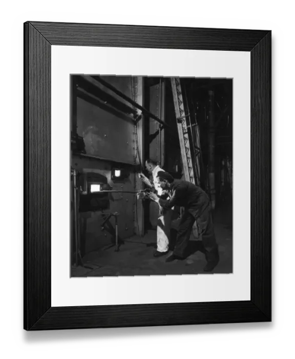 Framed Print : Metal being tempered in a furnace prior to shaping Framed Print : Metal being tempered in a furnace prior to shaping