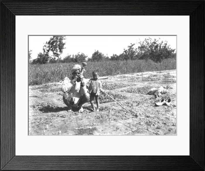 Framed Print : Father and child in a field, India Framed Print : Father and child in a field, India