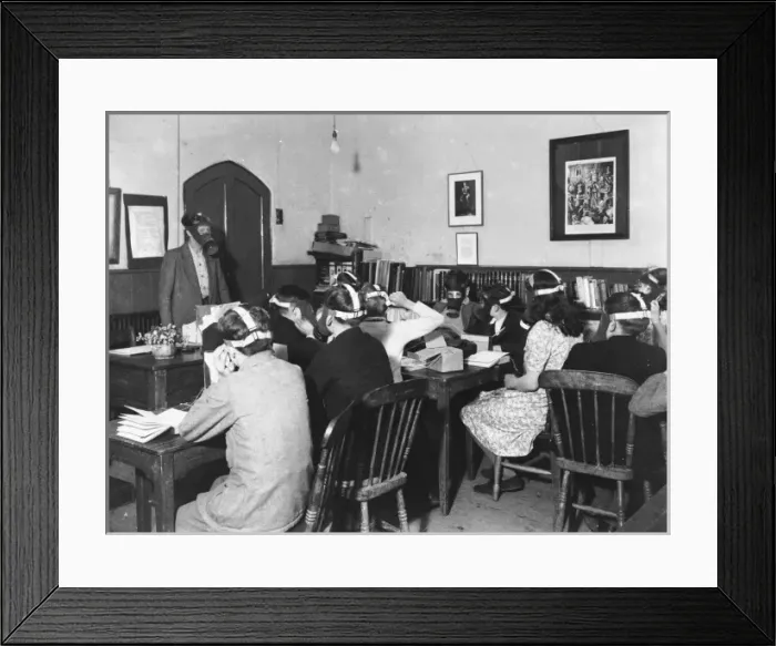 Framed Print : Gas Masks. Students wearing gas masks while studying during World War II Framed Print : Gas Masks. Students wearing gas masks while studying during World War II
