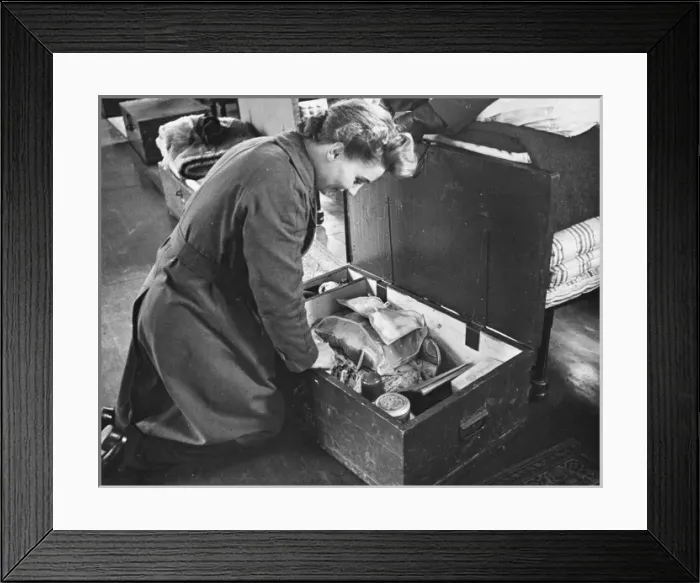 Framed Print : WaF WWII. A WaF inspects her locker at the end of her bed, which holds her tuck Framed Print : WaF WWII. A WaF inspects her locker at the end of her bed, which holds her tuck