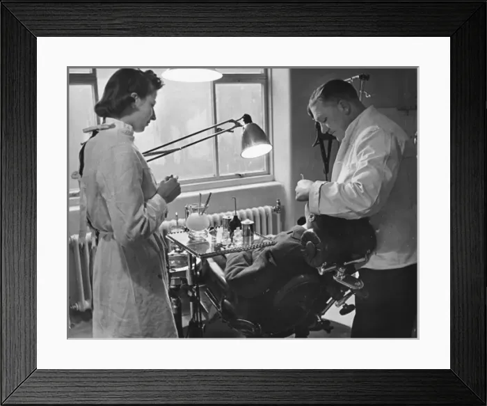 Framed Print : WaF WWII. A dentist at an RAF pilots training college is assisted by a Framed Print : WaF WWII. A dentist at an RAF pilots training college is assisted by a