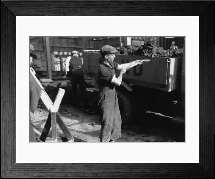 Framed Print : Shovelling rubble onto a lorry Framed Print : Shovelling rubble onto a lorry