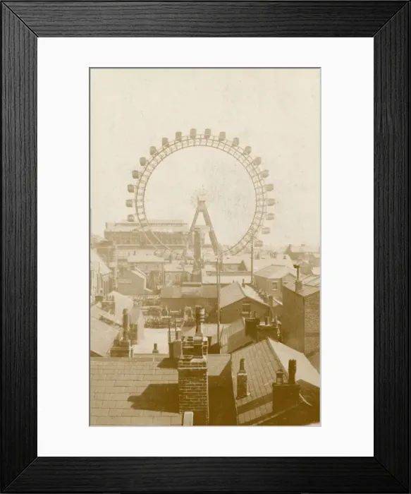 Framed Print : A ferris wheel viewed across the rooftops Framed Print : A ferris wheel viewed across the rooftops