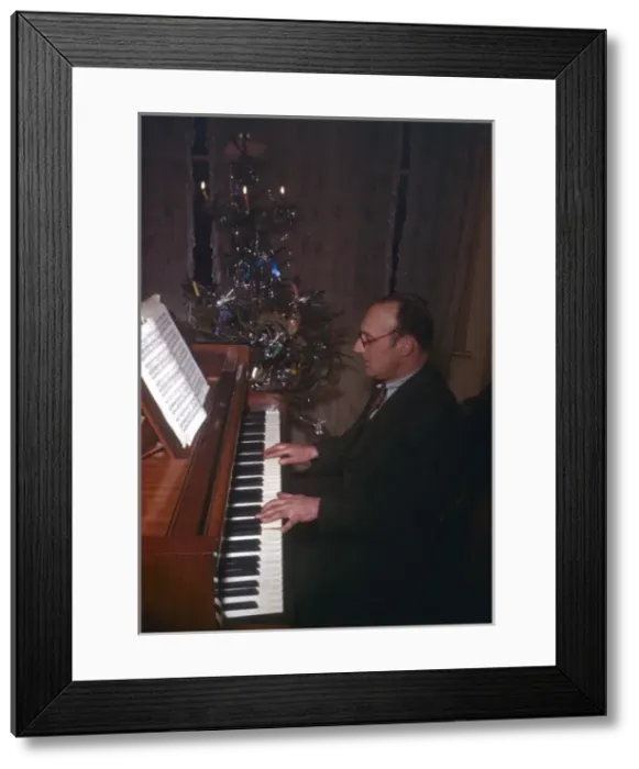 Framed Print : Man playing piano at Christmas Framed Print : Man playing piano at Christmas