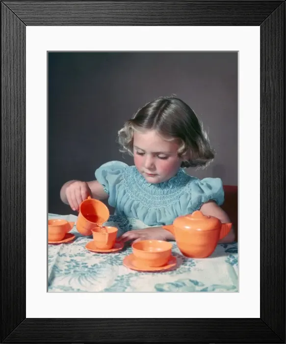 Framed Print : Little girl playing with toy tea set Framed Print : Little girl playing with toy tea set