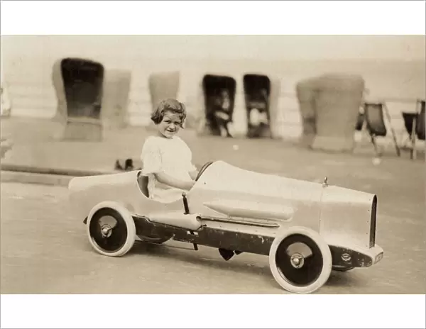 Small girl in a pedal car