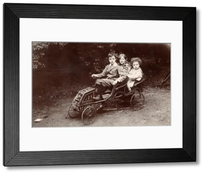 Framed Print : Three children in a toy car Framed Print : Three children in a toy car