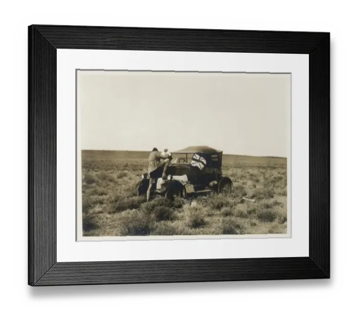 Framed Print : Man pouring water into car radiator, Middle East Framed Print : Man pouring water into car radiator, Middle East
