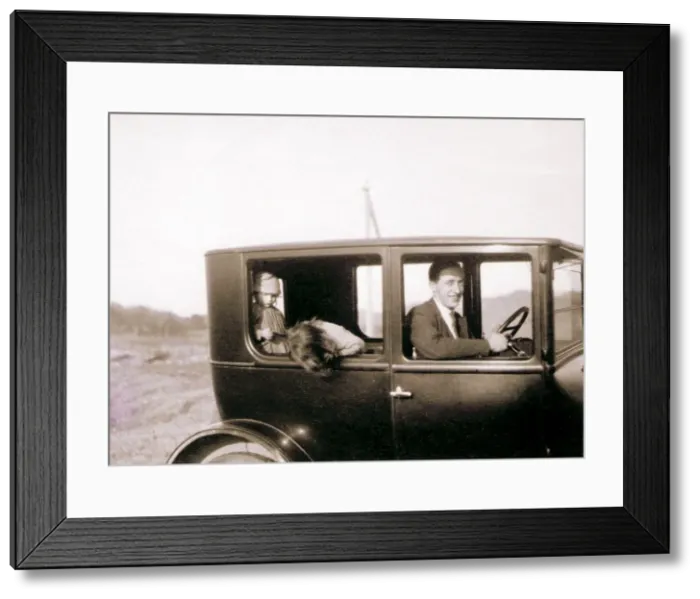 Framed Print : Man and two children in a car Framed Print : Man and two children in a car