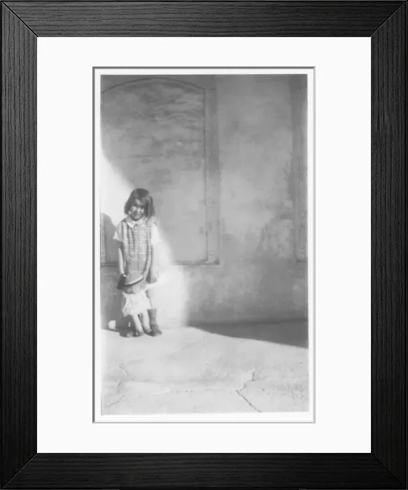 Framed Print : Little girl with doll, Middle East Framed Print : Little girl with doll, Middle East