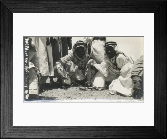 Framed Print : Two Bedouin men cooking lizard, Middle East Framed Print : Two Bedouin men cooking lizard, Middle East