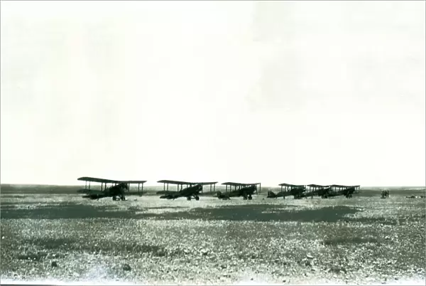Six biplanes lined up in the desert, Iraq