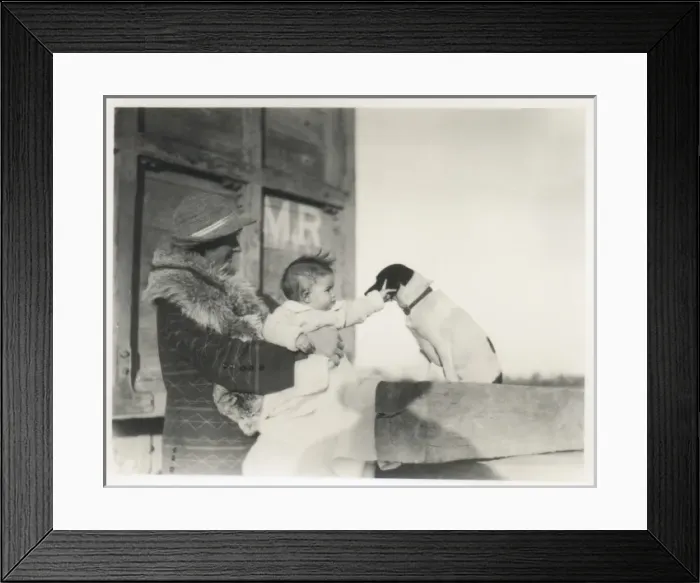 Framed Print : Fashionable mother with baby stroking pet dog Framed Print : Fashionable mother with baby stroking pet dog