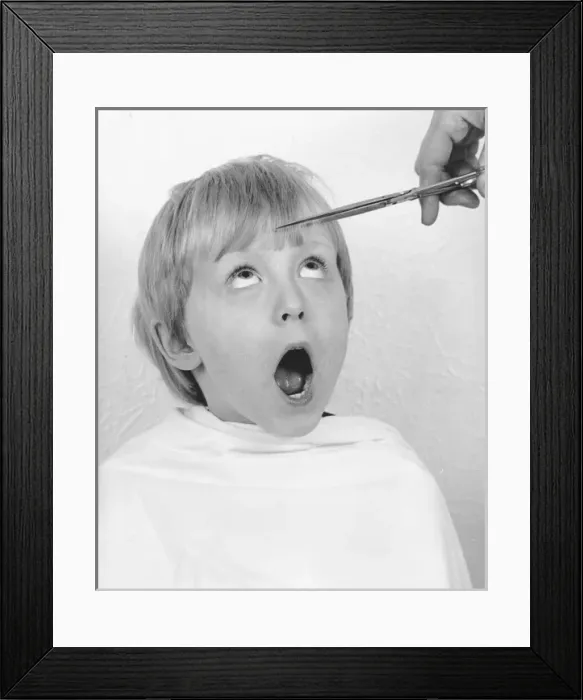 Framed Print : Young boy having a haircut Framed Print : Young boy having a haircut