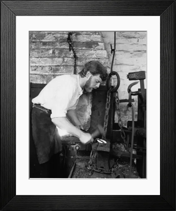 Framed Print : Blacksmith in his forge, working on a horseshoe Framed Print : Blacksmith in his forge, working on a horseshoe