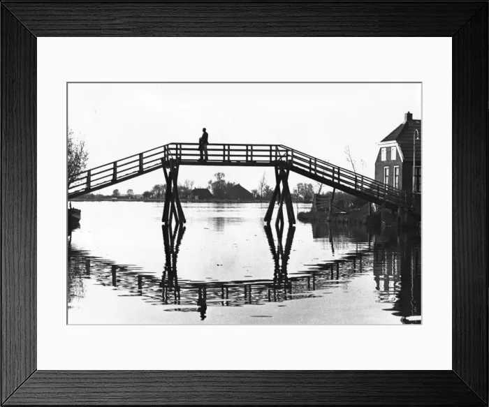 Framed Print : Bridge in silhouette over a stretch of water Framed Print : Bridge in silhouette over a stretch of water