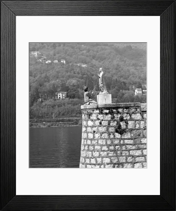 Framed Print : Boy kneeling in front of a religious statue Framed Print : Boy kneeling in front of a religious statue