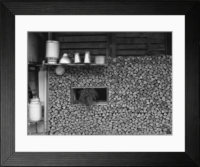 Framed Print : Logs stored under a chalet in Switzerland Framed Print : Logs stored under a chalet in Switzerland