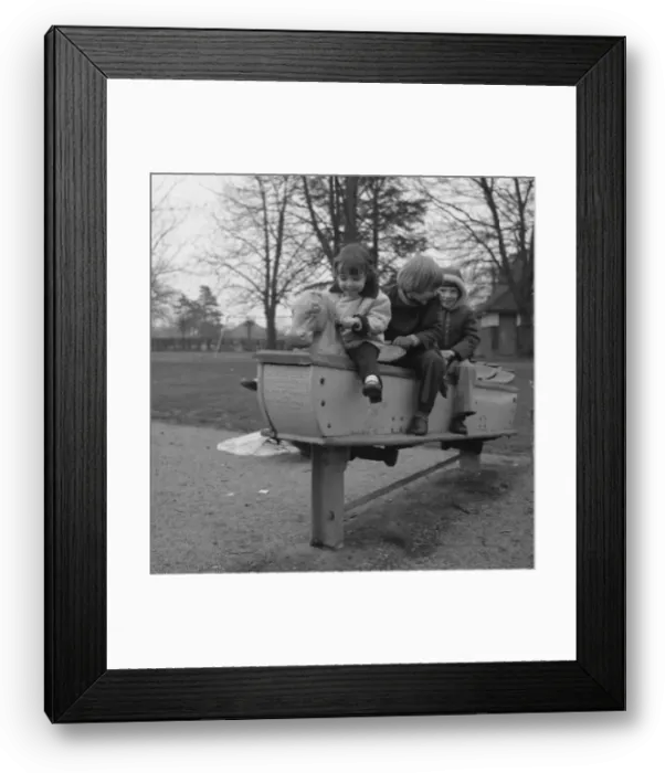 Framed Print : Three children on a playground ride Framed Print : Three children on a playground ride