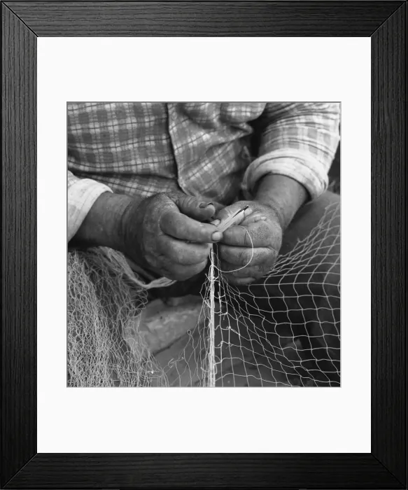 Framed Print : Close-up of fishermans hands, mending a net Framed Print : Close-up of fishermans hands, mending a net