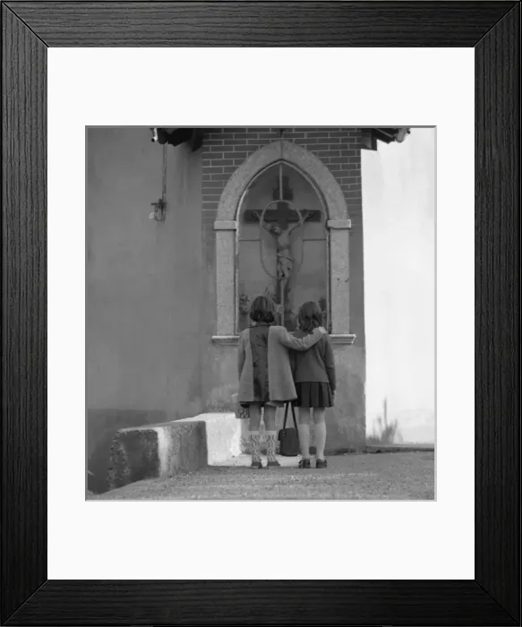 Framed Print : Two girls looking at a crucifix outside a church Framed Print : Two girls looking at a crucifix outside a church