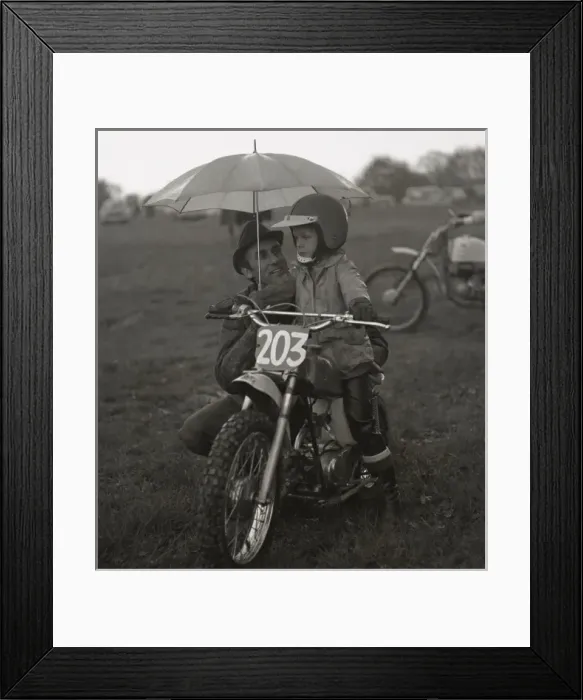 Framed Print : Man and boy with junior sized motorcycle Framed Print : Man and boy with junior sized motorcycle