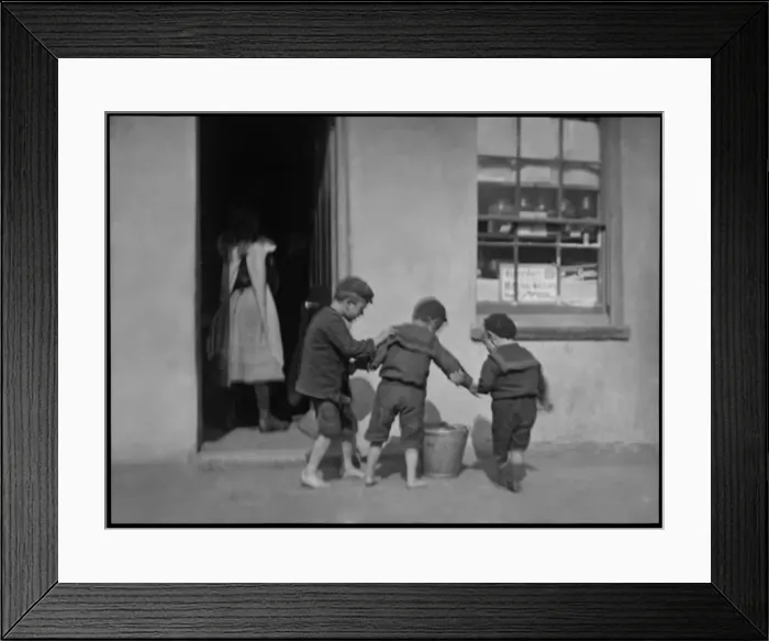 Framed Print : Three boys with a metal pail outside a shop Framed Print : Three boys with a metal pail outside a shop