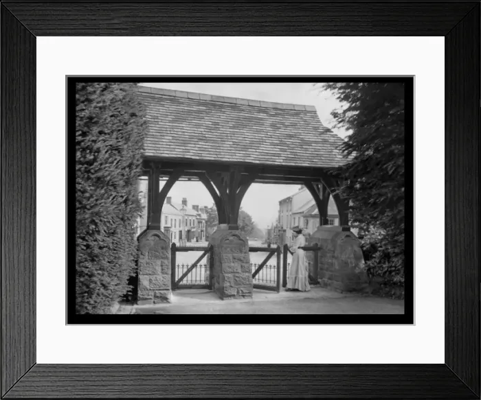 Framed Print : Woman standing at a roofed gate Framed Print : Woman standing at a roofed gate