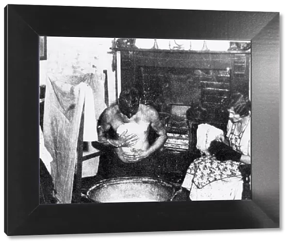 Miner washing at a tin bath, South Wales