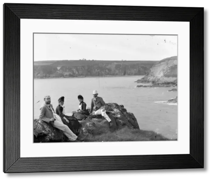 Framed Print : Two couples sitting on a cliff top