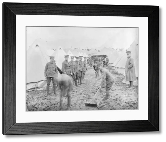 Framed Print : Soldiers cleaning up at a muddy training camp Framed Print : Soldiers cleaning up at a muddy training camp