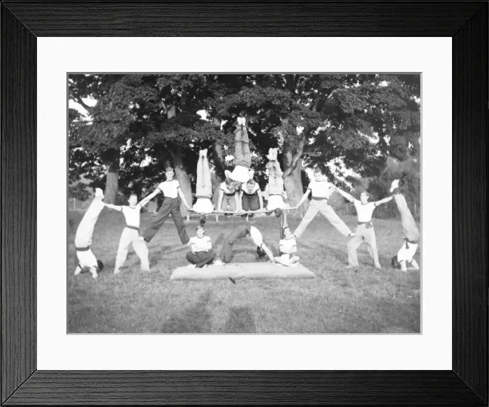 Framed Print : Group of servicemen doing acrobatics in a field Framed Print : Group of servicemen doing acrobatics in a field