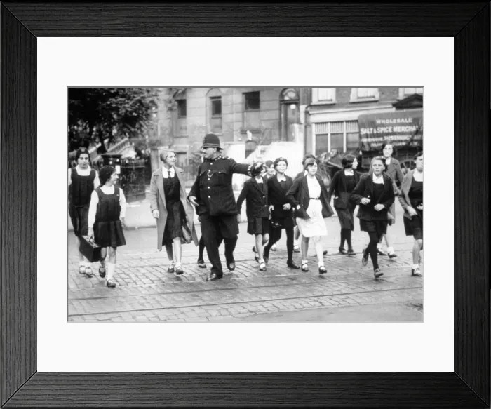 Framed Print : Policeman helping schoolgirls cross the road Framed Print : Policeman helping schoolgirls cross the road
