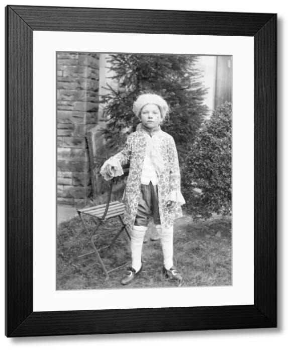 Framed Print : Young boy in Georgian costume in a garden, Mid Wales Framed Print : Young boy in Georgian costume in a garden, Mid Wales