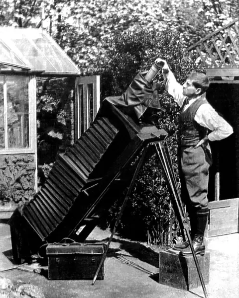 Reginald Malby with a giant camera in his garden