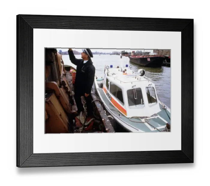 Framed Print : Policeman investigating a river barge Framed Print : Policeman investigating a river barge